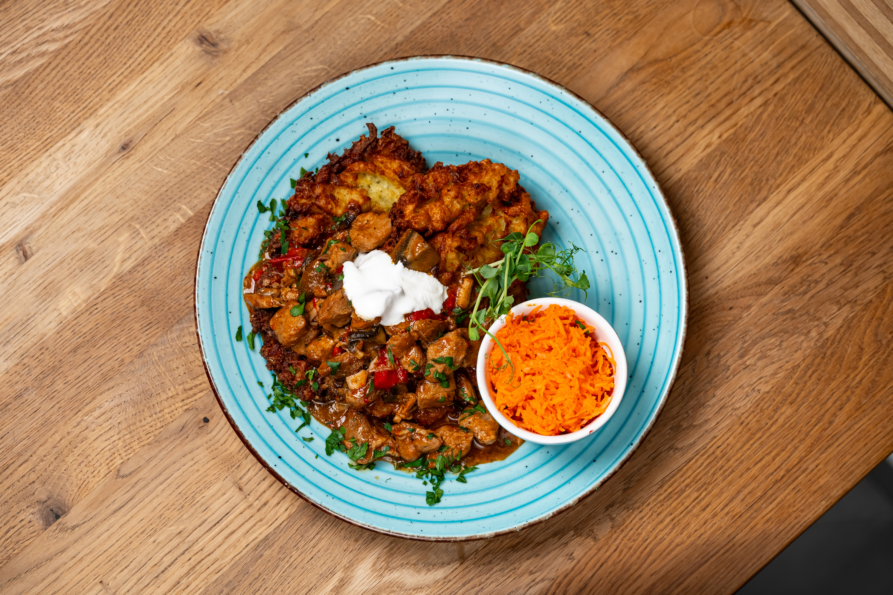 Hungarian-style potato pancakes with pork goulash